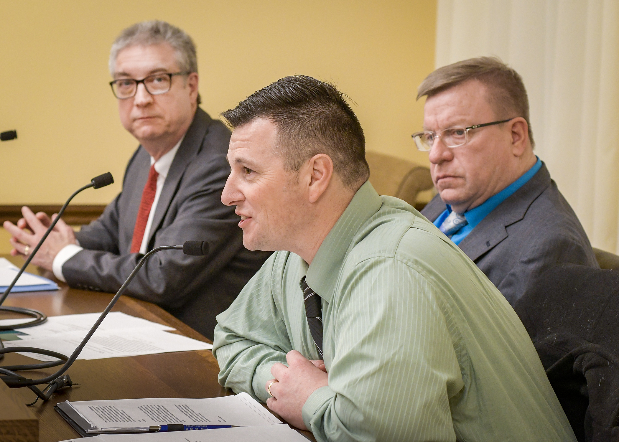 Justin Rost, center, interim director of Helmets to Hardhats Minnesota, and Gary Thaden, left, chair of the Construction Careers Foundation, testify before the House Labor Committee Jan. 23 in support of HF119. Photo by Andrew VonBank